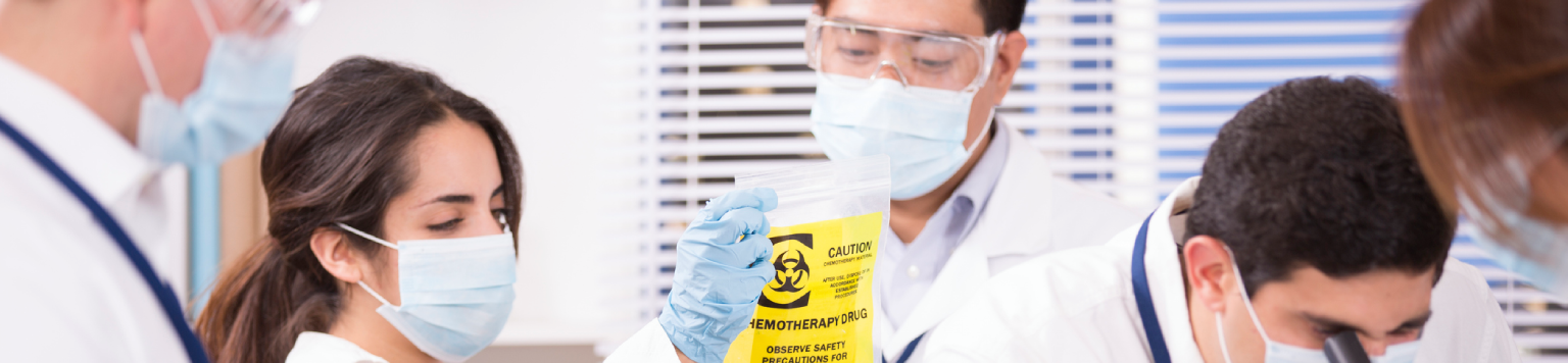 Scientists examining biohazard bag in laboratory.