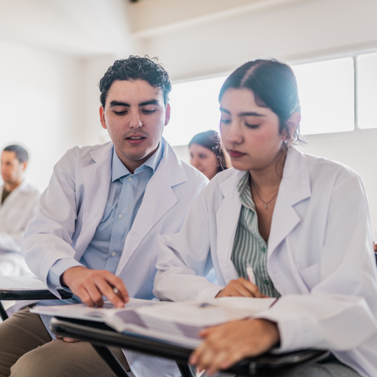 Medical students studying together in a classroom.