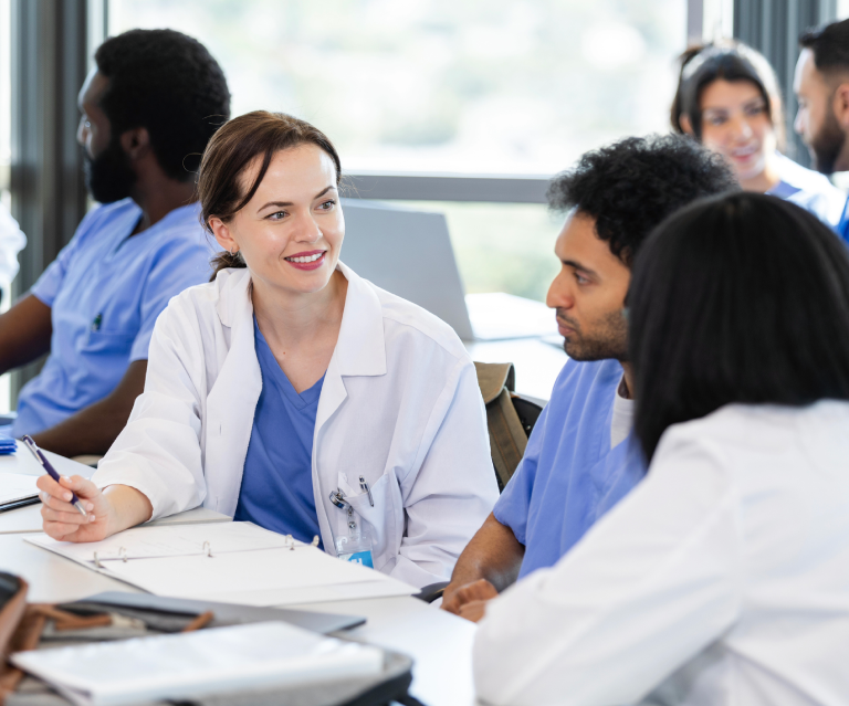 Medical professionals having a discussion at table.