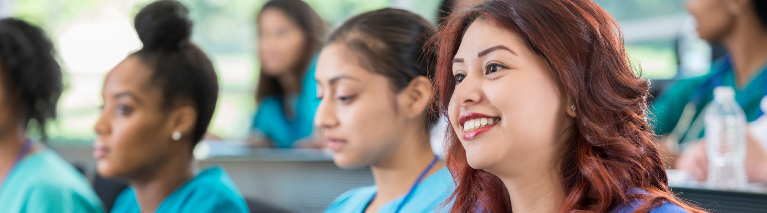 Nursing students attentively listening in class.