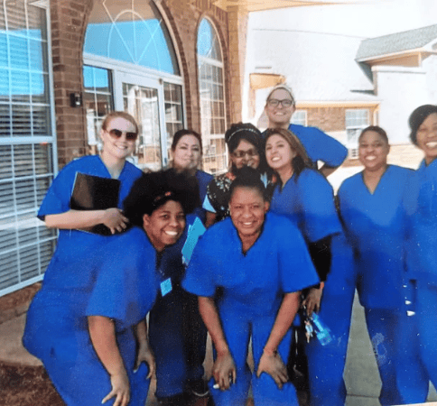 Smiling healthcare staff in blue scrubs