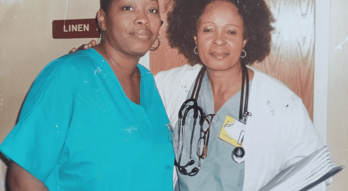 Two nurses posing with stethoscope and charts